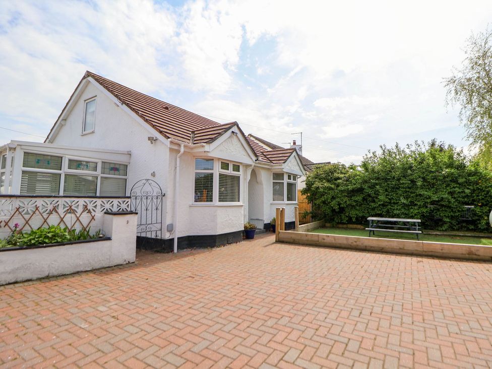 An outdoor area with a house, garden, and patio at Branwen in Talacre