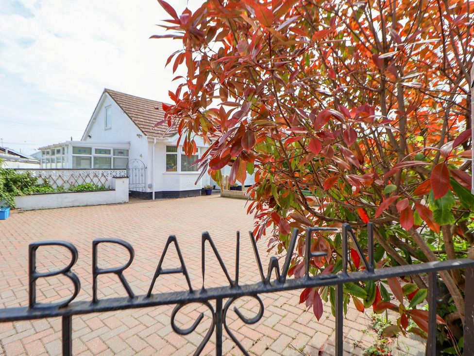 A house with a gate and driveway at Branwen in Talacre