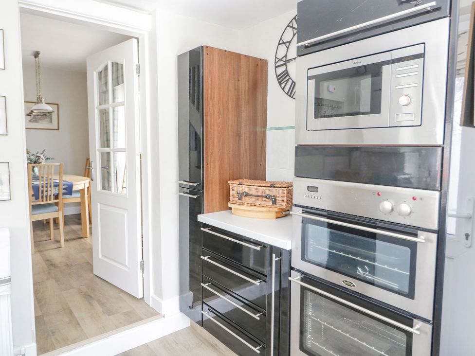 A kitchen with ovens and a microwave at Branwen in Talacre