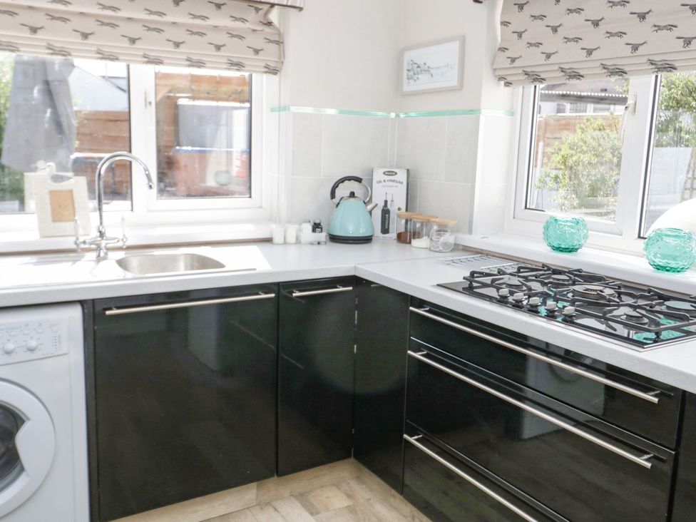 A kitchen with a sink and kettle at Branwen Talacre