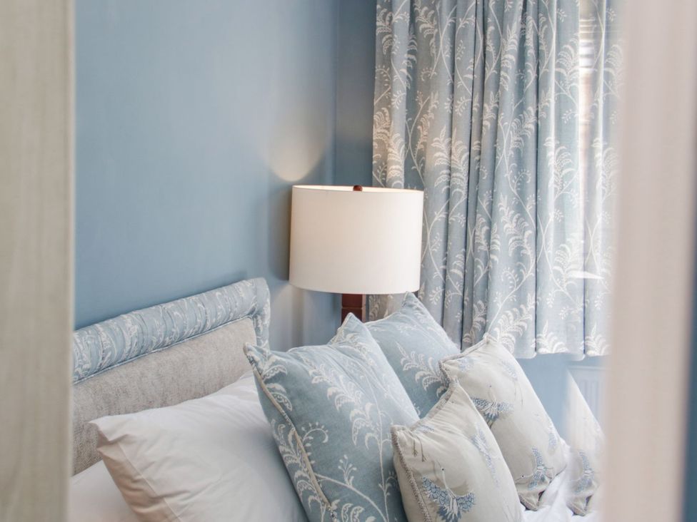 A bedroom with a bed and lamp at Branwen Talacre