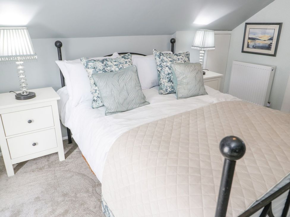 A bedroom with a bed and side tables at Branwen in Talacre