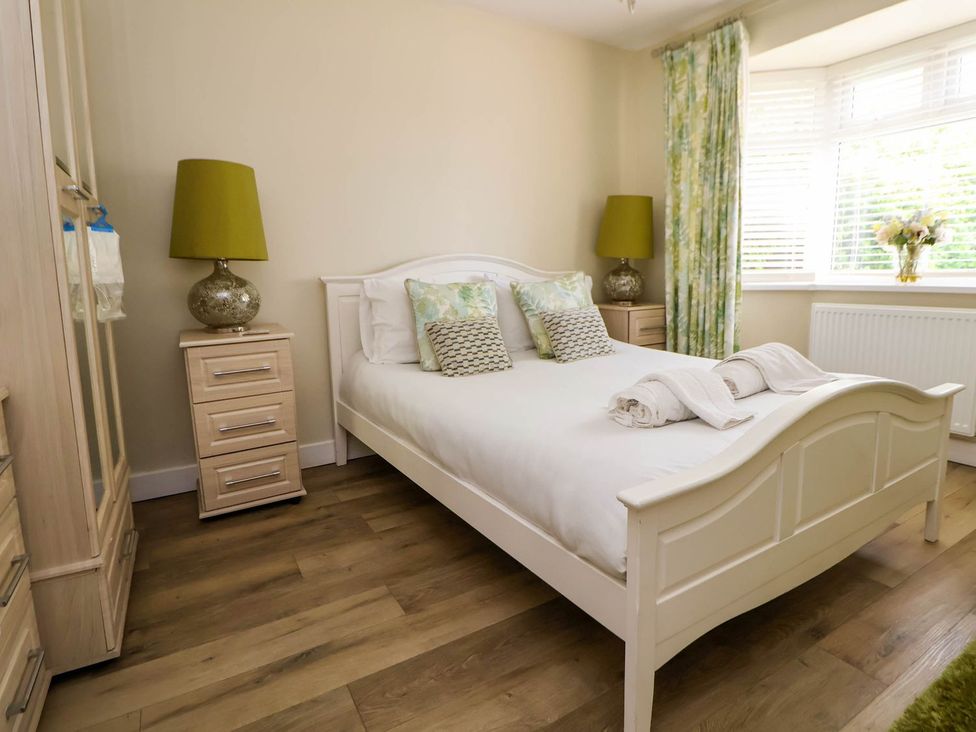 A bedroom with a bed and bedside table at Branwen in Talacre