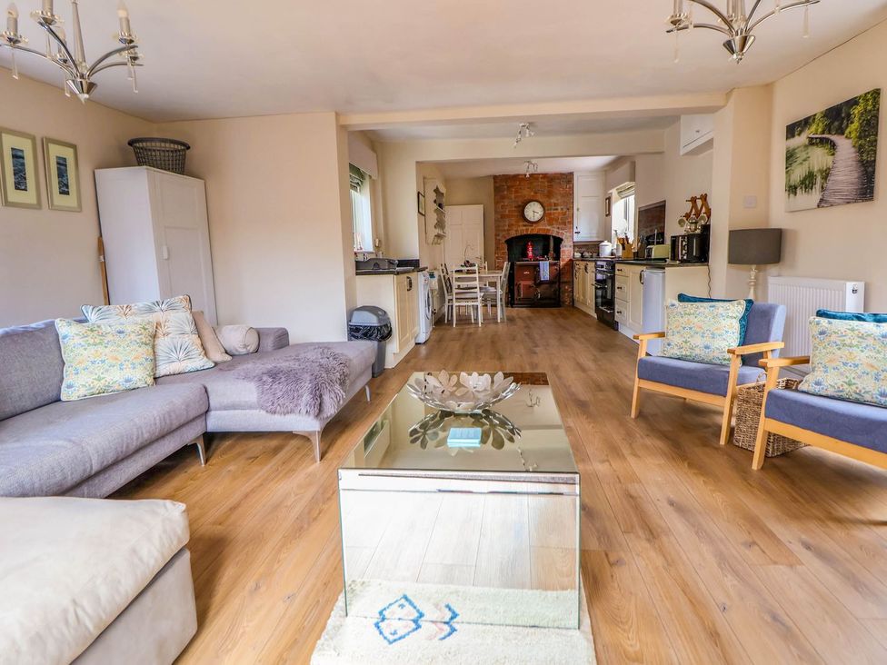 A living room with a sofa and coffee table at Brimrod in Talacre