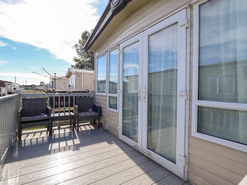An outdoor area with chairs and a view at Coastfields Holiday Village in Ingoldmells
