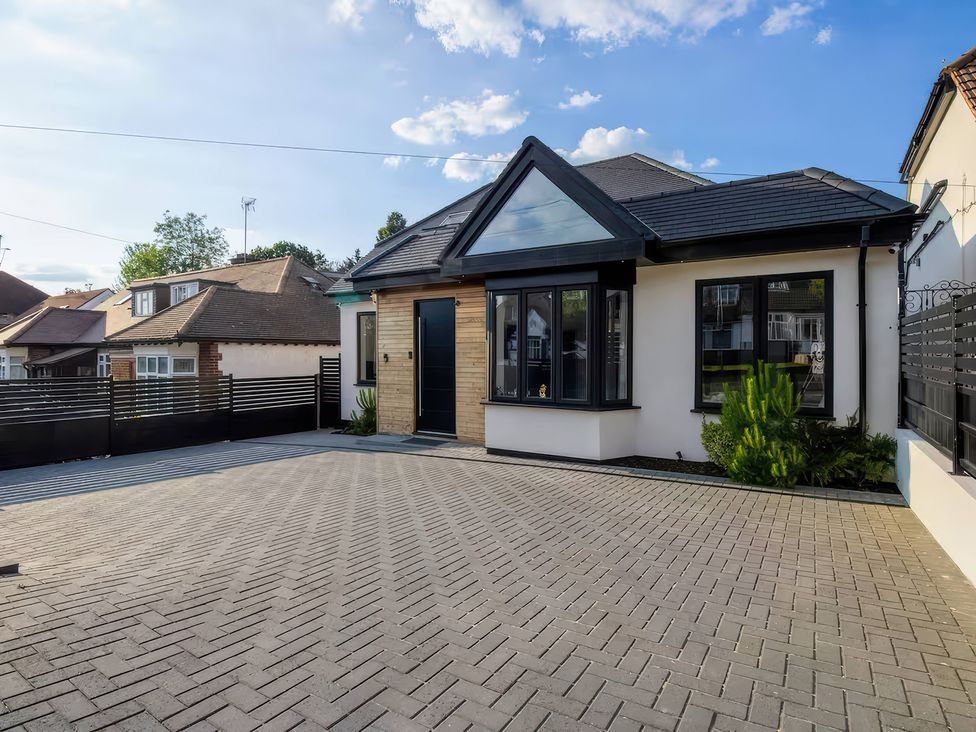 A bungalow with a front door and driveway at 19 Hillside Road Northwood, Hertfordshire