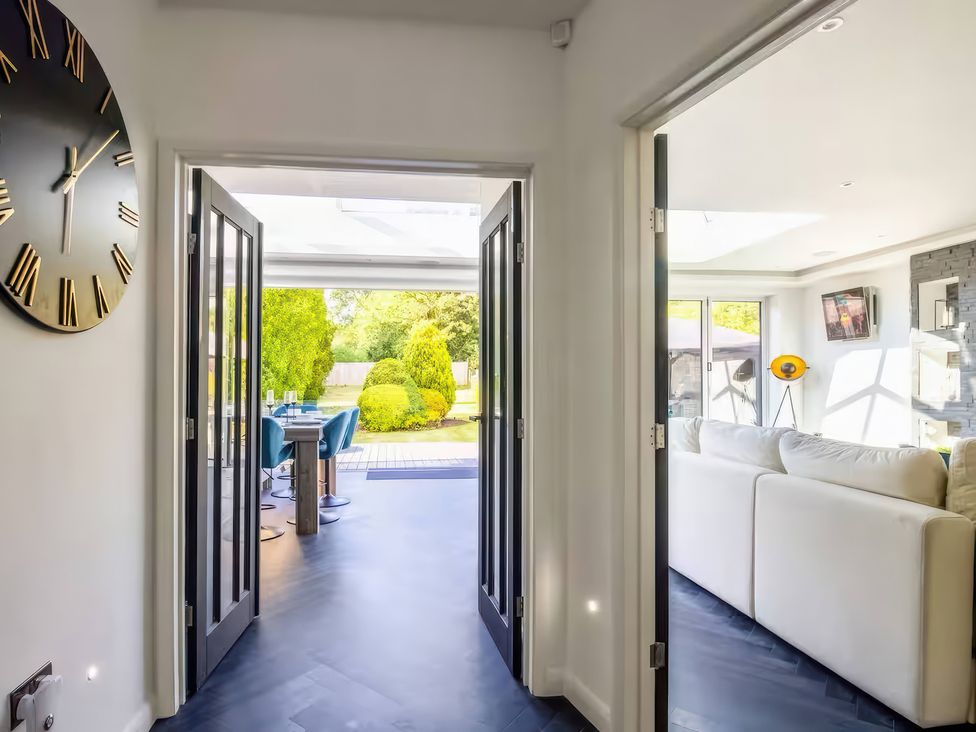 A hallway leading to a garden area at 19 Hillside Road in Northwood, Hertfordshire