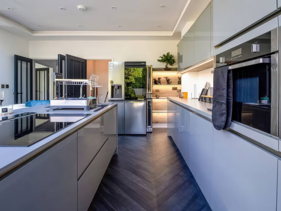A kitchen with modern appliances and cabinets at 19 Hillside Road Northwood, Hertfordshire