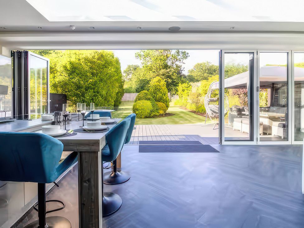 A kitchen with a view of the garden at 19 Hillside Road, Northwood, Hertfordshire