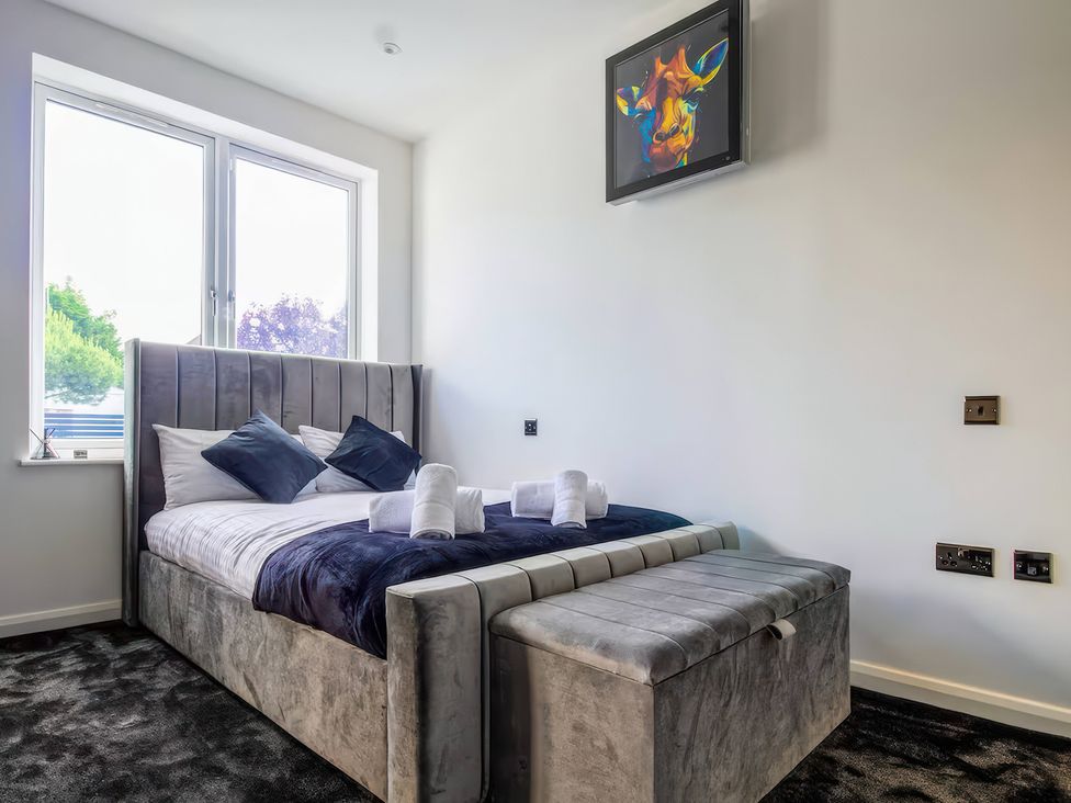 A bedroom with a bed and television at 19 Hillside Road Northwood, Hertfordshire