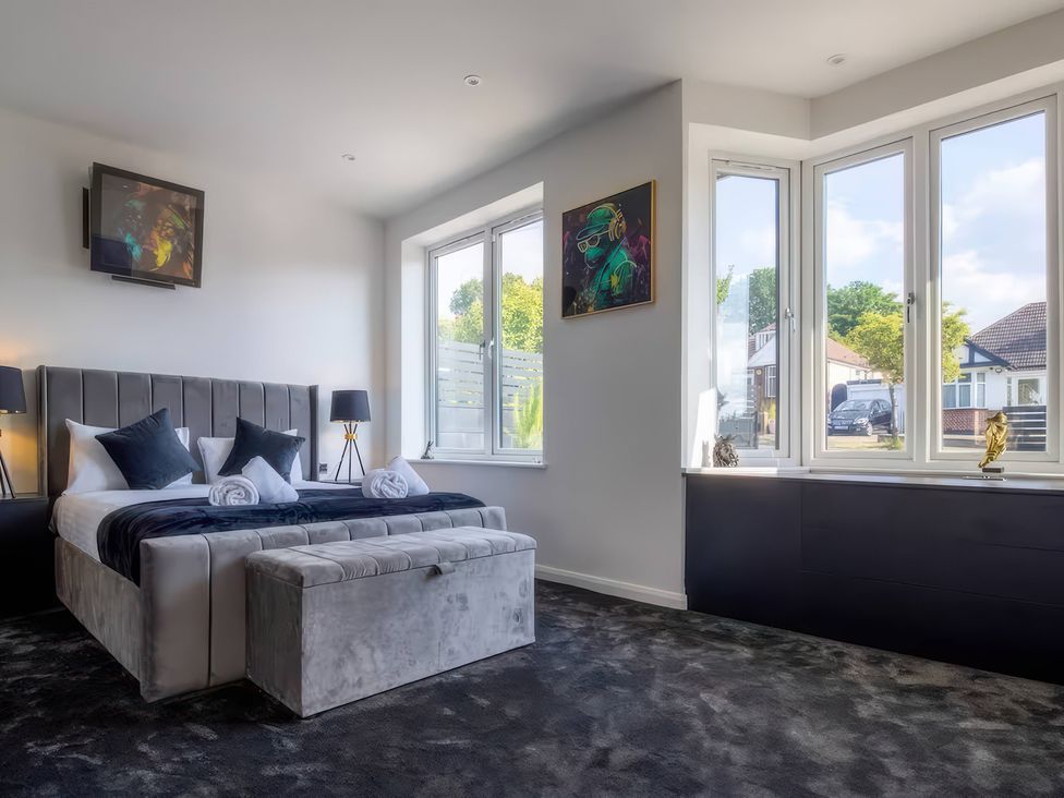 A bedroom with a bed and TV at 19 Hillside Road, Northwood, Hertfordshire