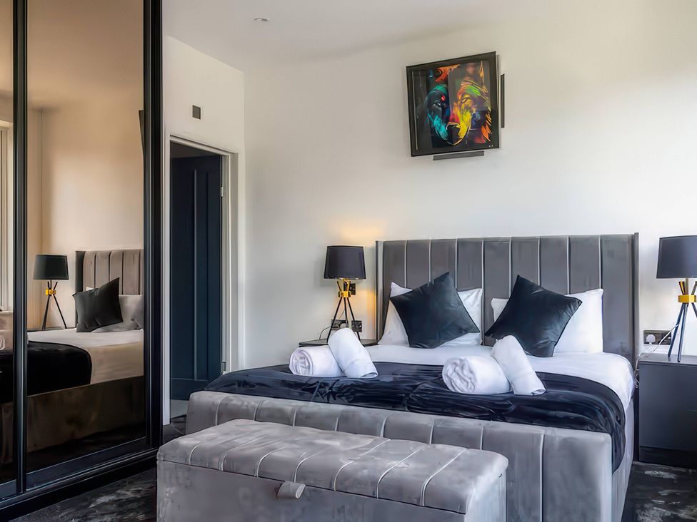 A bedroom with a bed and a television at 19 Hillside Road, Northwood, Hertfordshire