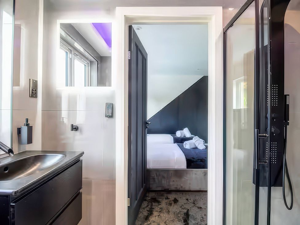 A bathroom with a sink and a shower at 19 Hillside Road, Northwood, Hertfordshire