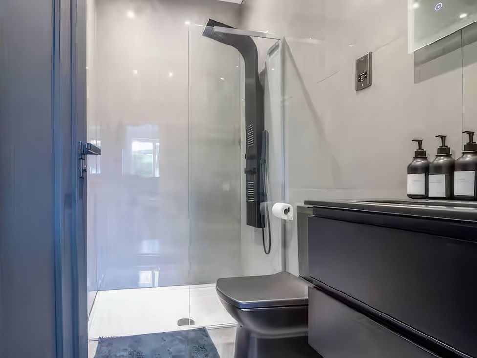 A bathroom with a shower and toilet at 19 Hillside Road Northwood, Hertfordshire