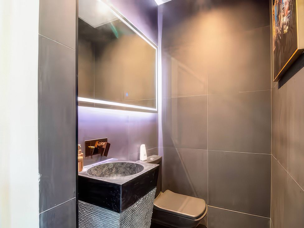 A bathroom with a sink and toilet at 19 Hillside Road Northwood, Hertfordshire