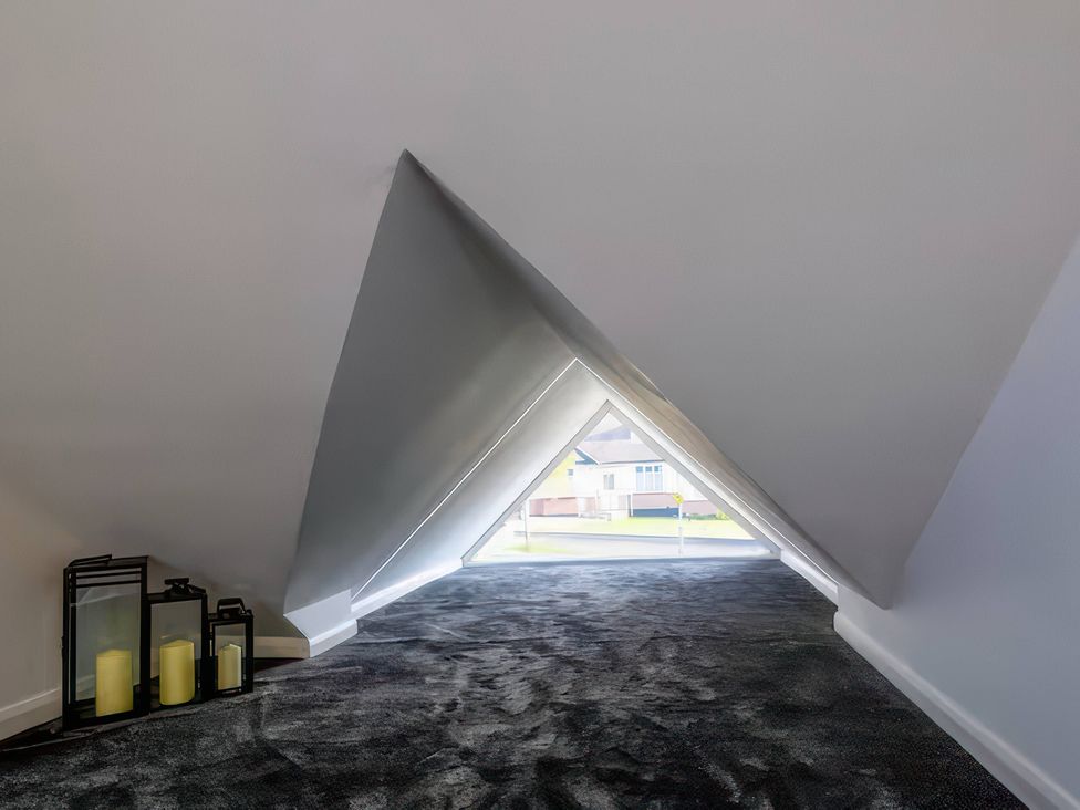 An attic with a window and lanterns at 19 Hillside Road, Northwood, Hertfordshire