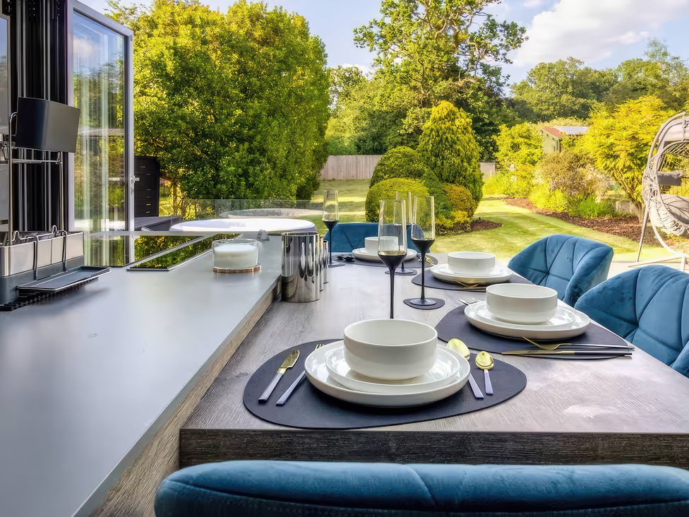 A dining area with a table set for meals at 19 Hillside Road Northwood, Hertfordshire