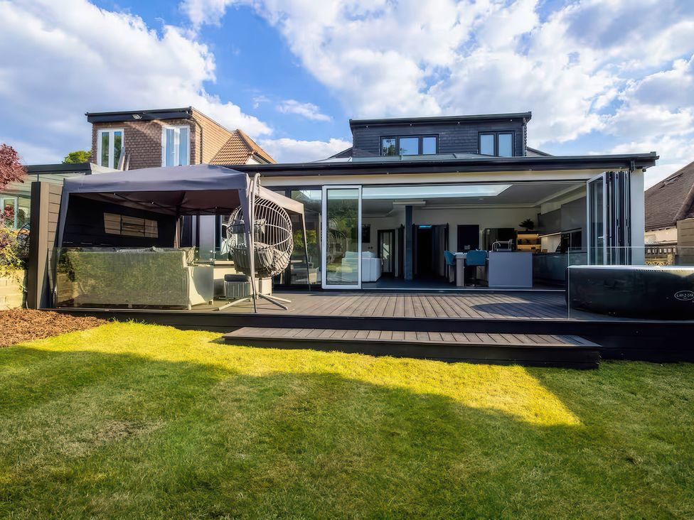 A house with a deck and garden at 19 Hillside Road in Northwood, Hertfordshire