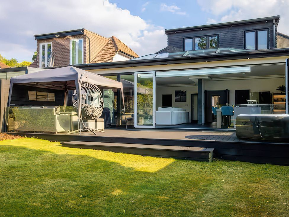 A house with a patio and tent at 19 Hillside Road Northwood, Hertfordshire