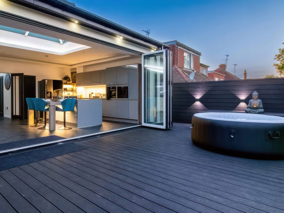 A kitchen with a hot tub outdoors at 19 Hillside Road Northwood, Hertfordshire