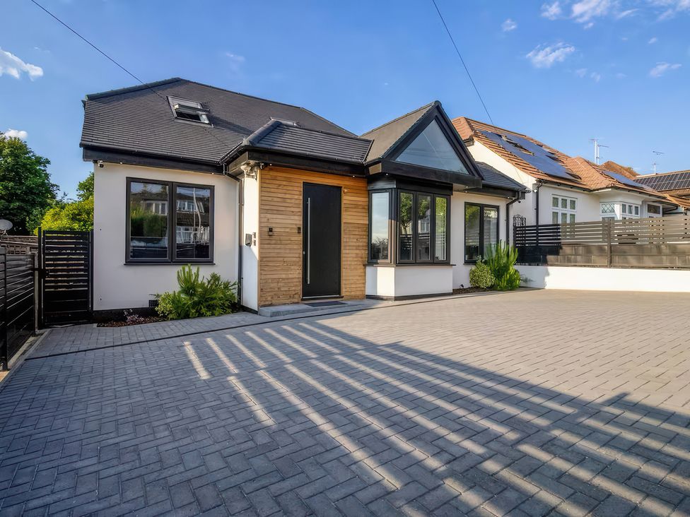 A house with a driveway and plants at 19 Hillside Road in Northwood, Hertfordshire