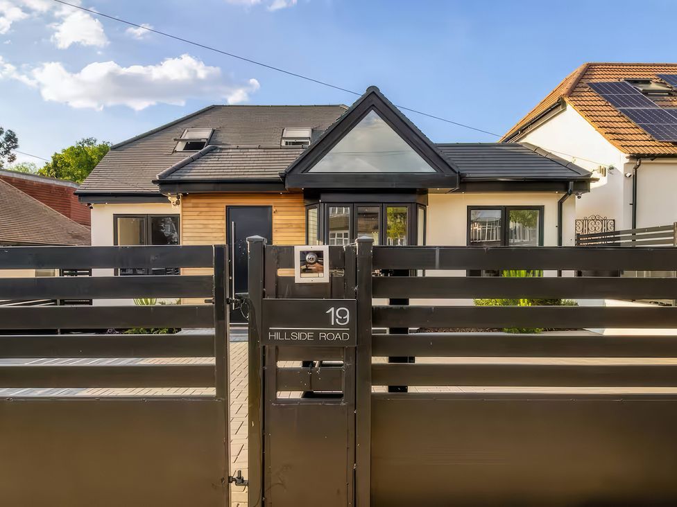 A house with a black gate at 19 Hillside Road in Northwood, Hertfordshire