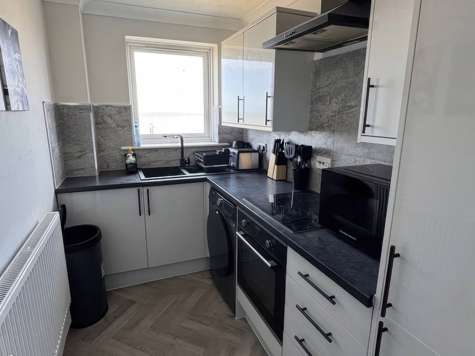 A kitchen with appliances and cabinets at Flat 3 Brown Lodge in Sheerness