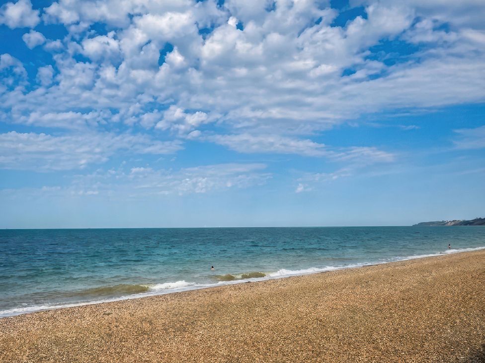 A beach with pebbles and ocean at Flat 3 Brown Lodge in Sheerness