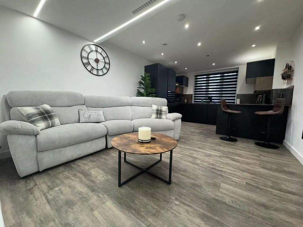 A living room with a sofa and coffee table at Flat 1 Hilltop Court in Uxbridge