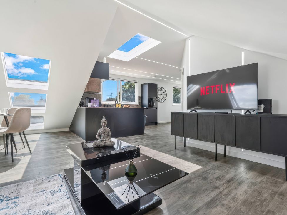 A living room with a television and coffee table at Flat 6, Hilltop Court in Uxbridge