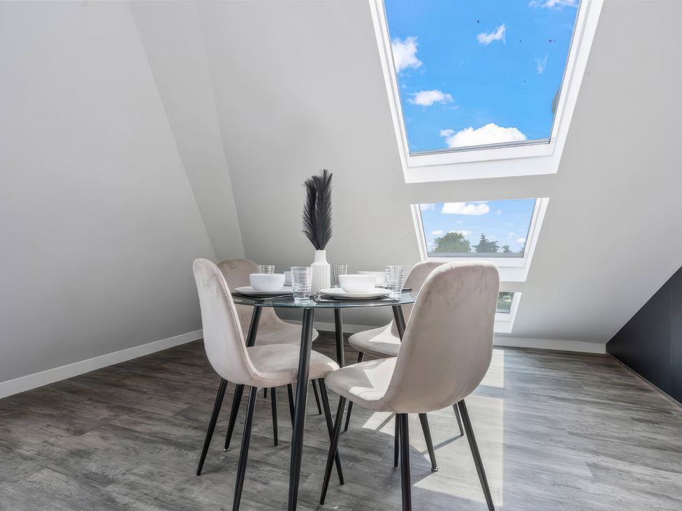 A dining room with a table and chairs at Flat 6, Hilltop Court Uxbridge