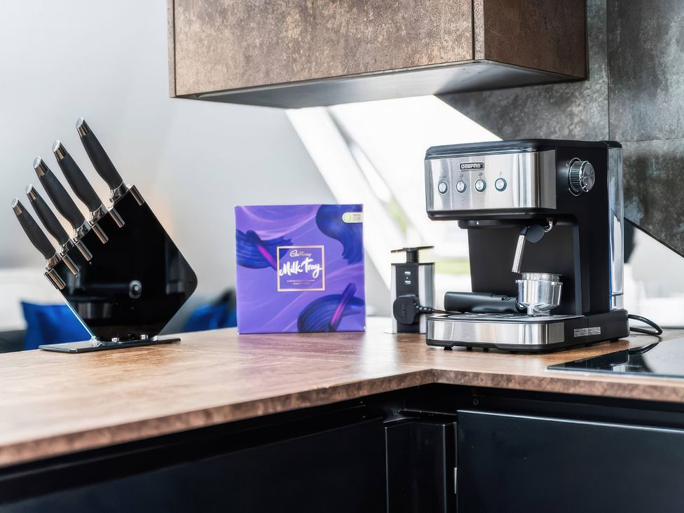 A kitchen with knives, a coffee machine, and a coffee packet at Flat 6, Hilltop Court Uxbridge