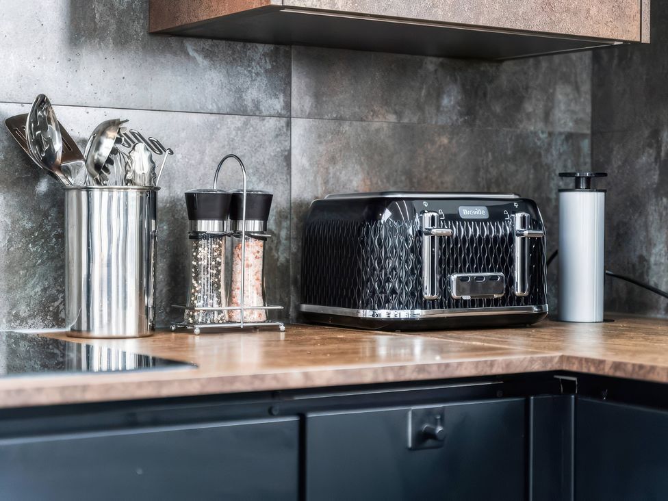 A kitchen countertop with utensils and a toaster at Flat 6, Hilltop Court Uxbridge