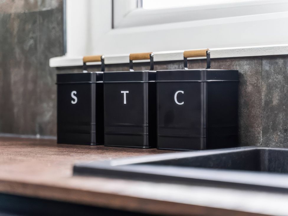 Kitchen countertop with black bins labeled S, T, and C at Flat 6, Hilltop Court in Uxbridge