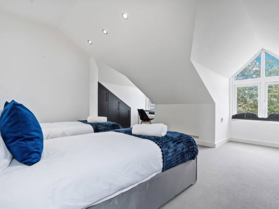 A bedroom with two beds and a window at Flat 6, Hilltop Court in Uxbridge