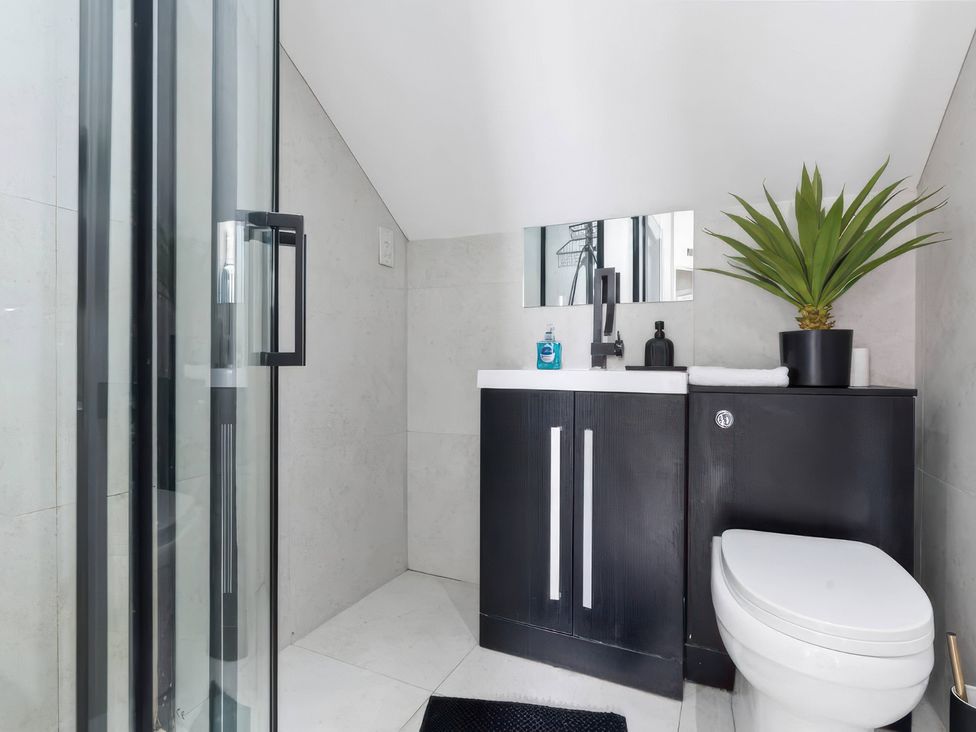 A bathroom with a shower, sink, and toilet at Flat 6, Hilltop Court Uxbridge