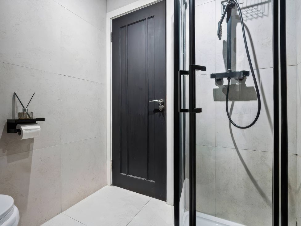 A bathroom with a shower and toilet at Flat 6, Hilltop Court in Uxbridge