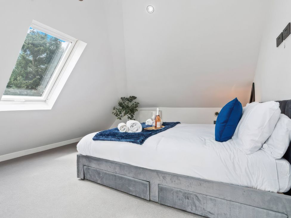 A bedroom with a bed and a window at Flat 6, Hilltop Court Uxbridge