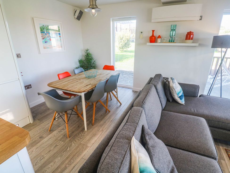 A dining room with a table and chairs at 74 Porthmeor in Redruth