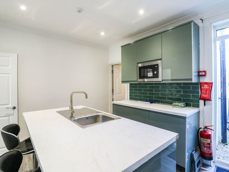 A kitchen with a countertop and sink at Gillingham House in Gillingham, Kent