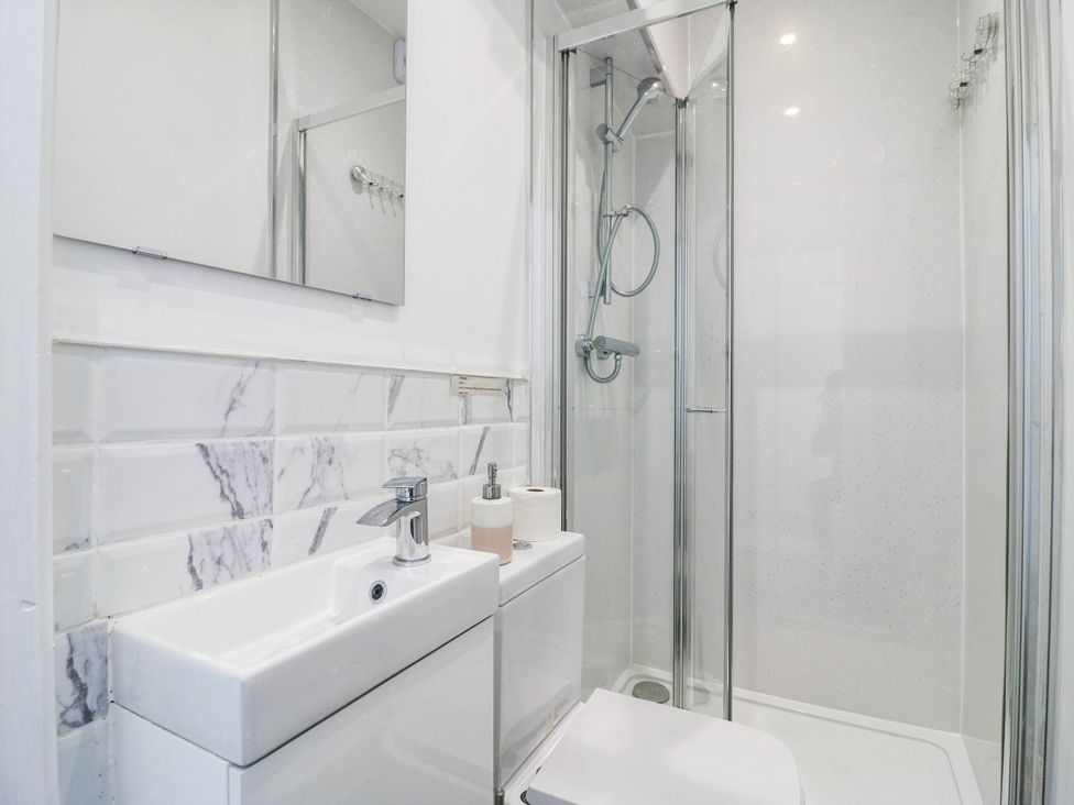 A bathroom with a sink, toilet, and shower at Gillingham House, Gillingham, Kent