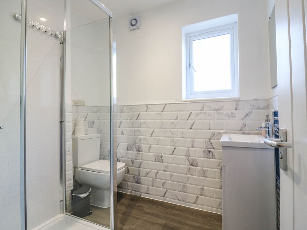A bathroom with a shower, toilet, and sink at Gillingham House in Gillingham, Kent
