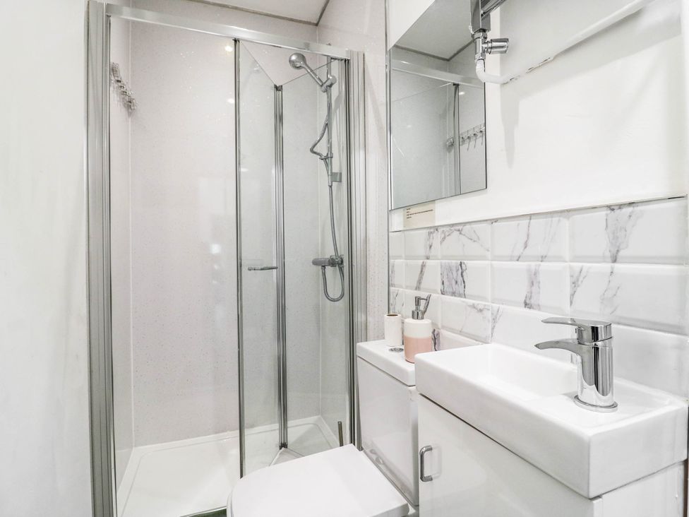 A bathroom with shower, toilet, and sink at Gillingham House in Gillingham, Kent