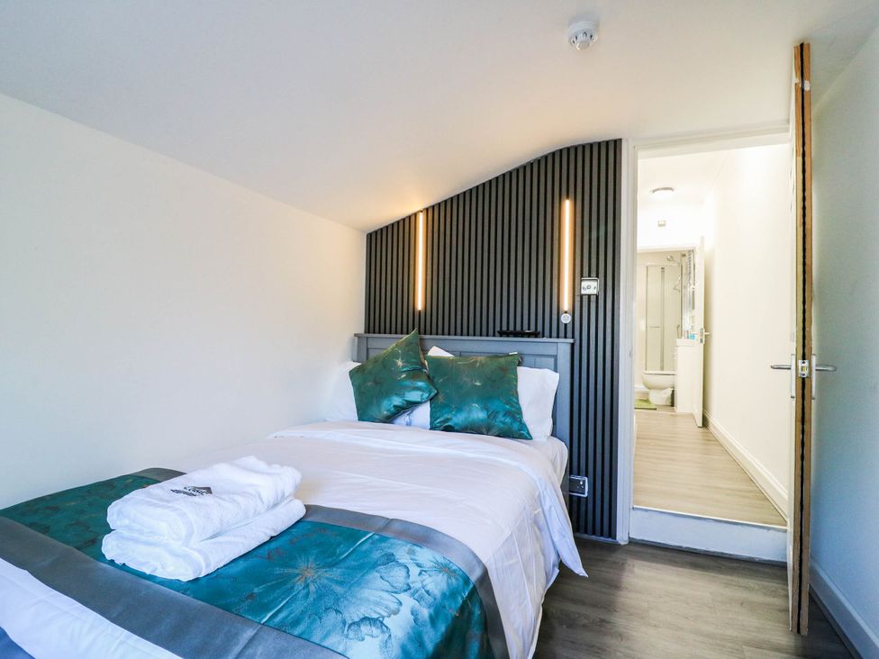 A bedroom with a bed and an attached bathroom at Gillingham House in Gillingham, Kent