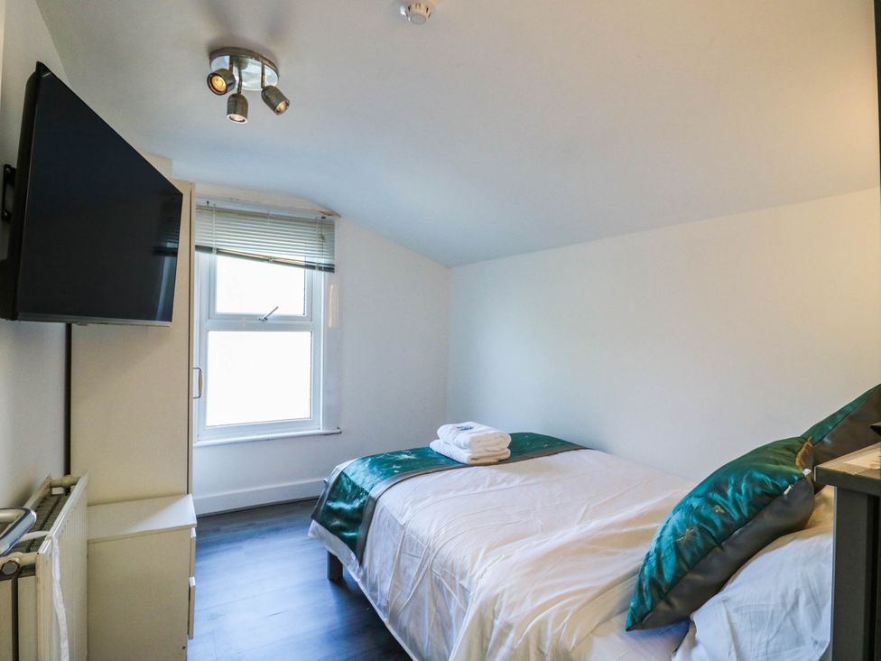 A bedroom with a bed and a television at Gillingham House in Gillingham, Kent