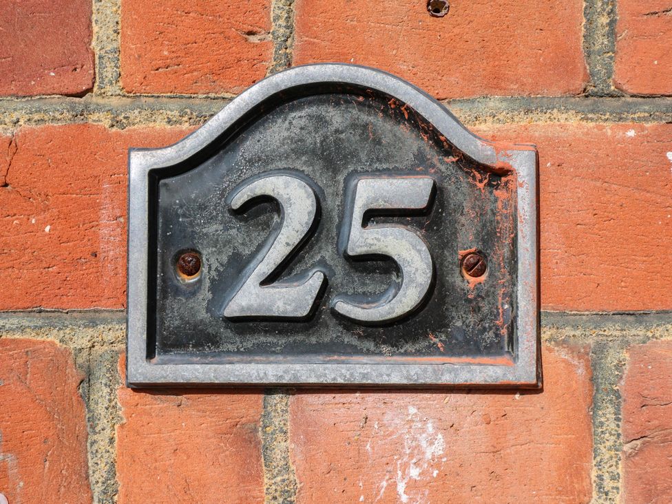 A house number plaque displaying the number 25 at Gillingham House in Gillingham, Kent