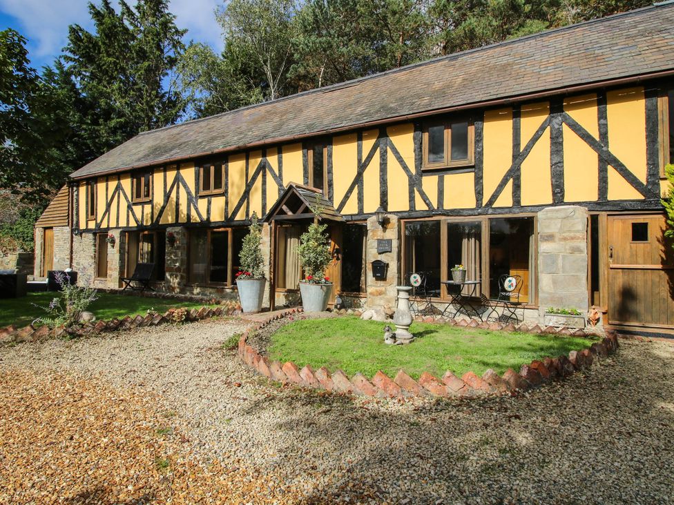 A house with a garden area and seating at The Duck House at Hyssington Farm near Montgomery
