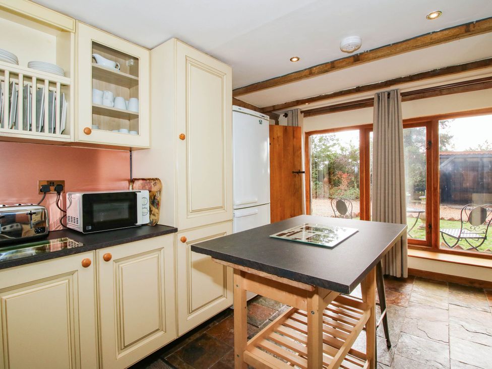 A kitchen with appliances and a table at The Duck House at Hyssington Farm near Montgomery