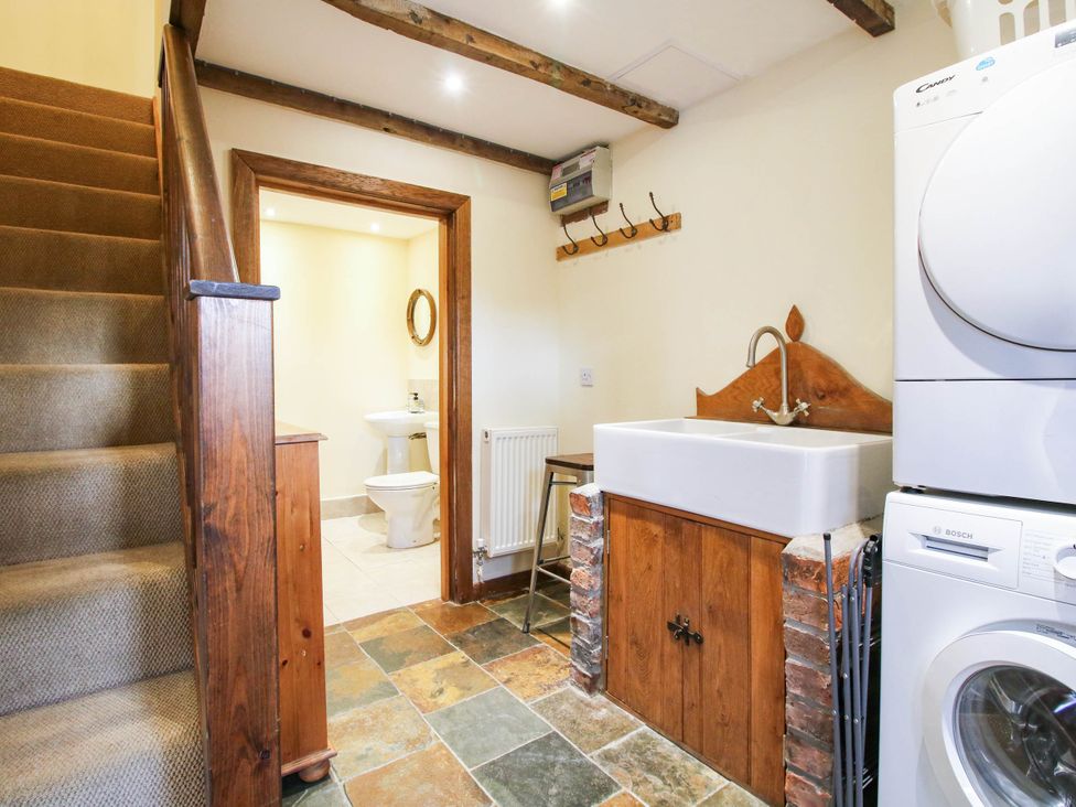 A laundry room with a sink and washing machine at The Duck House at Hyssington Farm near Montgomery