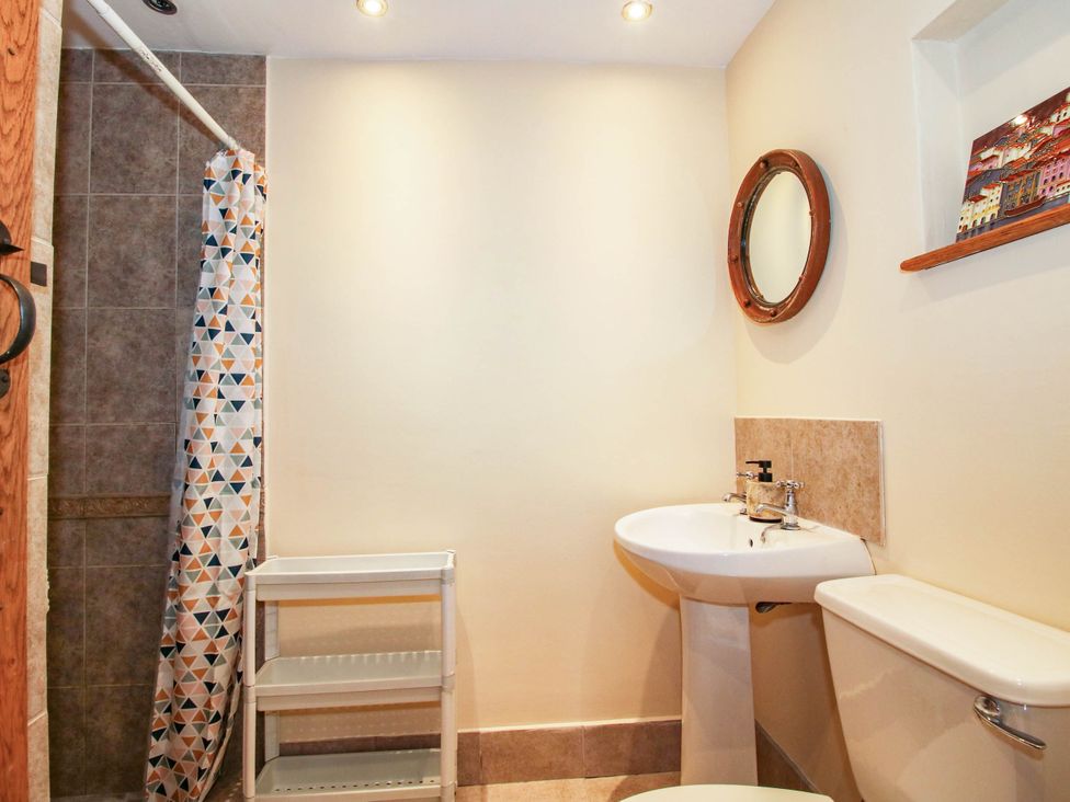 A bathroom with a shower, sink, and toilet at The Duck House at Hyssington Farm near Montgomery